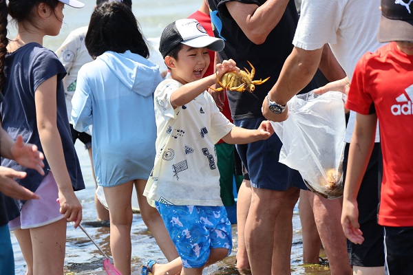 カニをつかむ少年