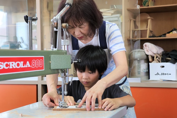 糸のこの使い方を教わる男の子