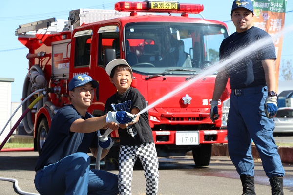 笑顔で放水を体験する児童